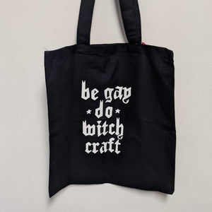 Black tote bag by Midge Blitz reads: be gay do witchcraft in white text  available at Coyote Supply Co, a zero waste witch store in Midtown Reno, Nevada that is BIPOC owned