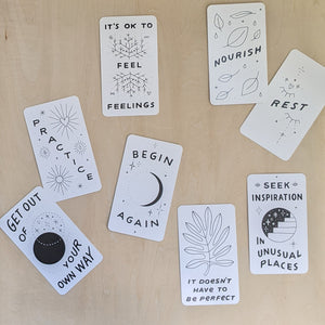 8 cards from the Inquire Within Deck feature black drawings on white paper cards that read: get out of your own way, practice, it's ok to feel feelings, nourish, rest, seek inspiration in unusual places, it doesn't have to be perfect, & begin again