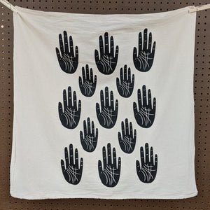 Zero waste universal cloth.  Unbleached cotton with black ink, 5 rows of alternating sized hands.  Witch made by The Rainbow Vision available at Coyote Supply Co, a zero waste witch store in Midtown Reno, Nevada that is BIPOC owned