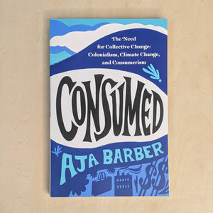 Blue book cover by Aja Barber. Reads "Consumed" in black block letters available at Coyote Supply Co, a zero waste witch store in Midtown Reno, Nevada that is BIPOC owned