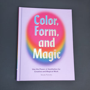 Light purple book by Nicole Pivirotto. Reads "color, form, and magic" in holographic silver  block letters and features a rainbow oval under the text available at Coyote Supply Co, a zero waste witch store in Midtown Reno, Nevada that is BIPOC owned