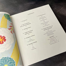 Load image into Gallery viewer, The book Asian American Herbalism open to its table of contents pictured on a dark background.
This item is sold at Coyote Supply Co a BIPOC and LGBTQIA+ owned zero waste witch store in Reno Nevada