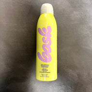 Yellow Bask sunscreen bottle with a white spray cap on a dark grey background.

The bottle reads:
Bask, non-aerosol invisible mist sunscreen, broad spectrum SPF 50 continuous spray, water & sweat resistant. 

Sold at Coyote Supply Co a BIPOC and LGBTQIA+ owned zero waste witch store in Reno Nevada 