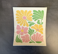 A white square dish cloth with a colorful flower print pictured on a dark background.

This item is sold at Coyote Supply Co a BIPOC and LGBTQIA+ owned zero waste witch store in Reno Nevada