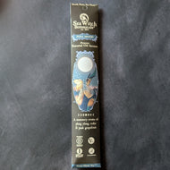 A glossy black cardboard envelope with blue embellishments. The envelope has an illustration of a firefly hanging out on a flower under a full moon.
The envelope reads, 