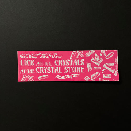 A bright pink bumper sticker with white text that reads: On my way to... Lick all the Crystals at the Crystal Store You can't stop me! Featuring various crystal formations.  Sold at Coyote Supply Co a BIPOC and LGBTQIA+ owned zero waste witch store in Reno Nevada 