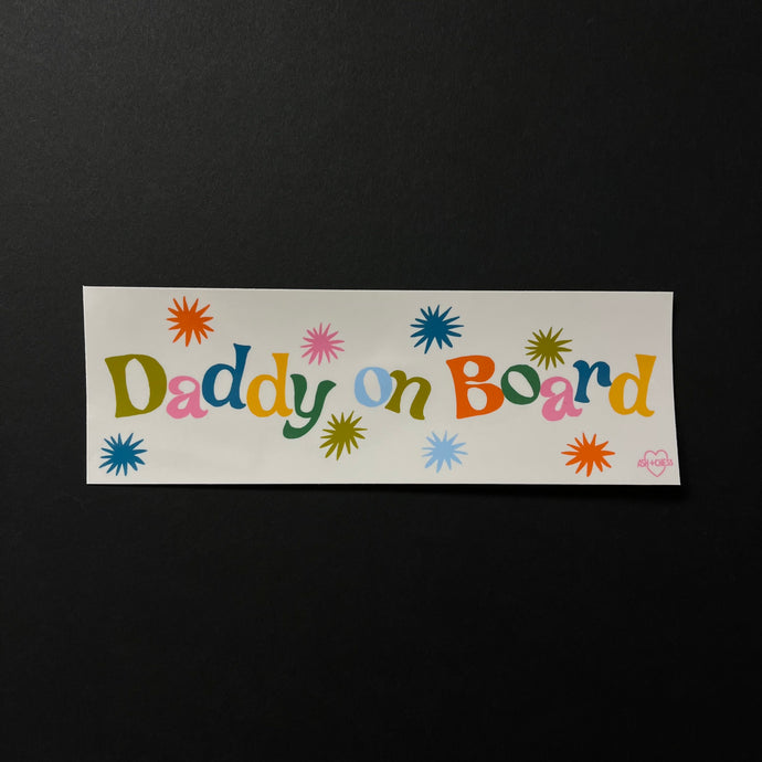 A white bumper sticker with multi color text that reads: Daddy on Board.  Sold at Coyote Supply Co a BIPOC and LGBTQIA+ owned zero waste witch store in Reno Nevada 