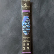 A glossy black cardboard envelope with blue embellishments. The envelope has an illustration of a snow covered fir tree under a n moon.
The envelope reads, 