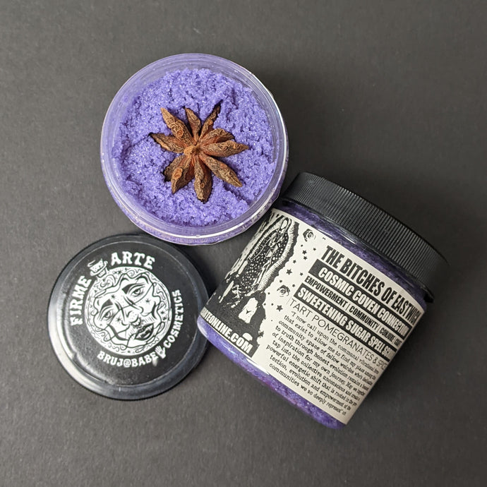 Purple sugar scrub in a plastic container with a black and white label that reads The Bitches of Eastwick. Sold at Coyote Supply Co a BIPOC and LGBTQIA+ owned zero waste witch store in Reno Nevada