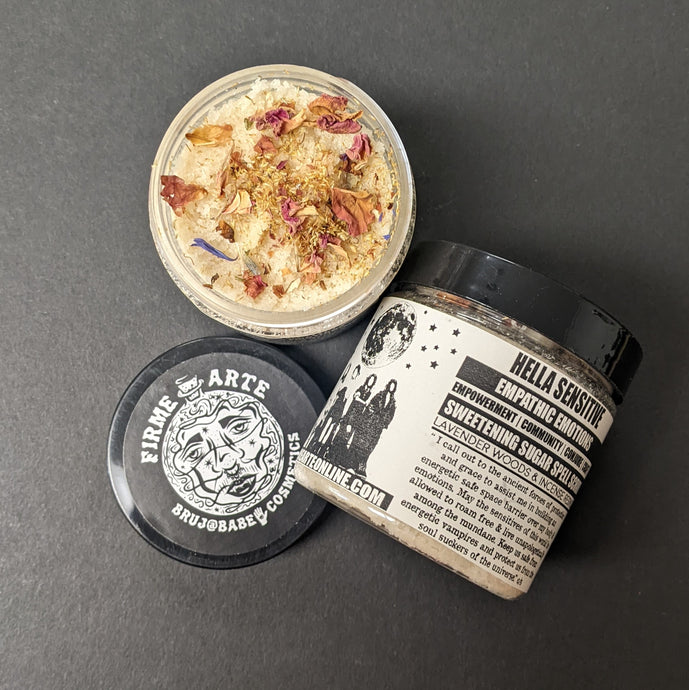 White sugar scrub in a plastic container with a black and white label that reads Hella Sensitive. Sold at Coyote Supply Co a BIPOC and LGBTQIA+ owned zero waste witch store in Reno Nevada