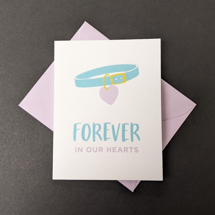 A white card with an illustration of a pet collar that reads Forever in our Hearts. Sold at Coyote Supply Co a BIPOC and LGBTQIA+ owned zero waste witch store in Reno Nevada 