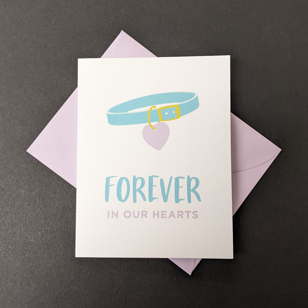 A white card with an illustration of a pet collar that reads Forever in our Hearts. Sold at Coyote Supply Co a BIPOC and LGBTQIA+ owned zero waste witch store in Reno Nevada 