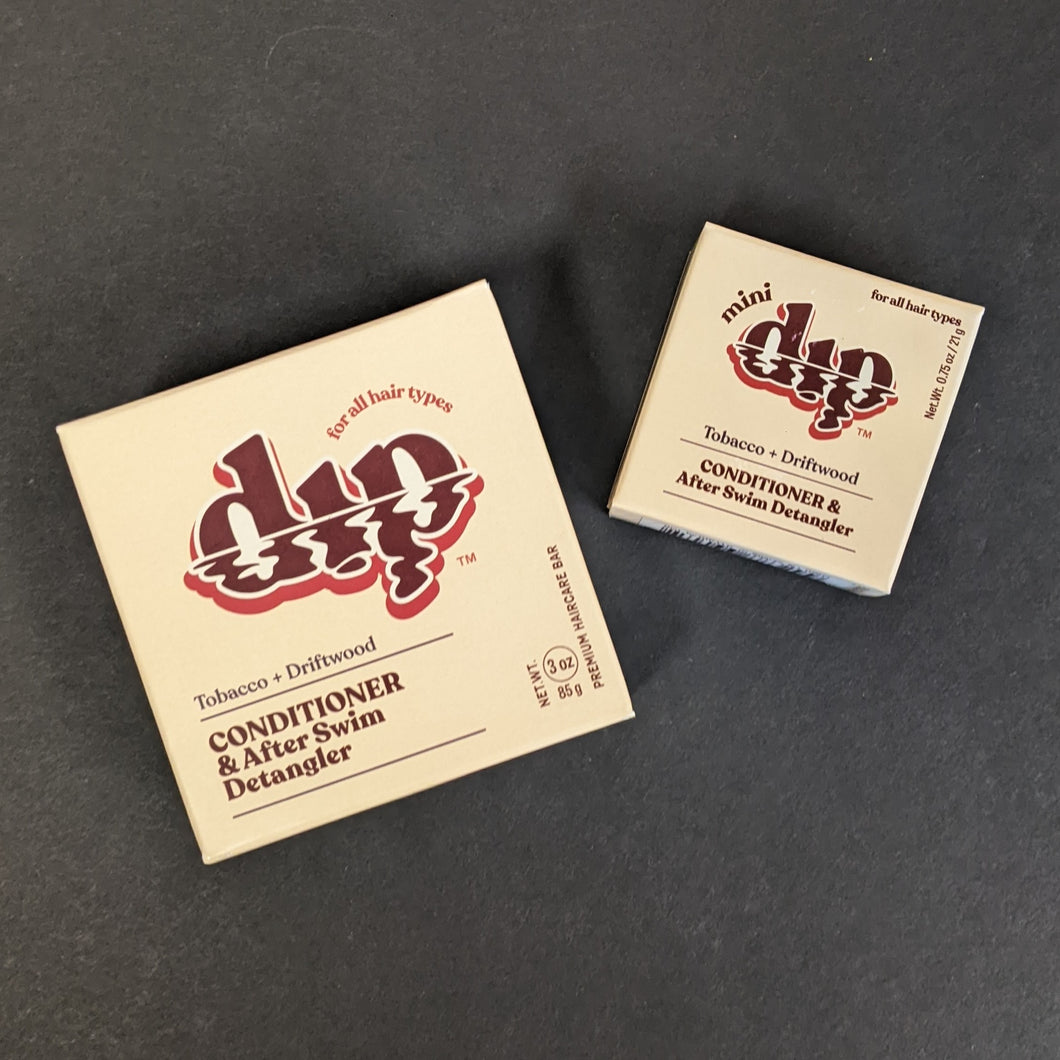 Dip Tobacco + Driftwood Conditioner in a light brown box in regular 4oz and .75oz travel sizes. Sold at Coyote Supply Co a BIPOC and LGBTQIA+ owned zero waste witch store in Reno Nevada