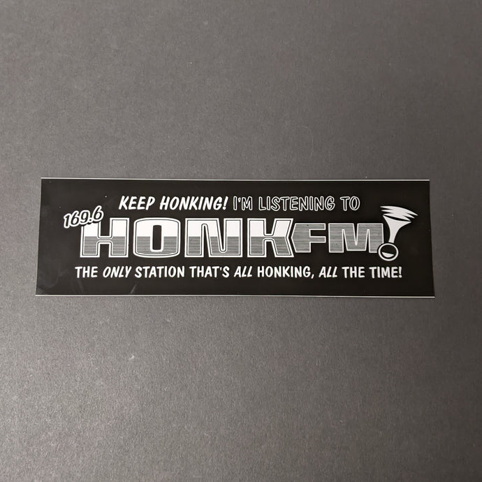 A black bumper sticker with a horn and white text that reads: Keep honking! I'm listening to 169.6 HONK FM! The only station that's all honking, all the time!  Sold at Coyote Supply Co a BIPOC and LGBTQIA+ owned zero waste witch store in Reno Nevada 