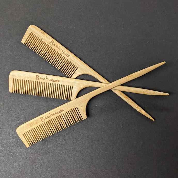 Three bamboo combs laid on top of each other on a black background.  Sold at Coyote Supply Co a BIPOC and LGBTQIA+ owned zero waste witch store in Reno Nevada 