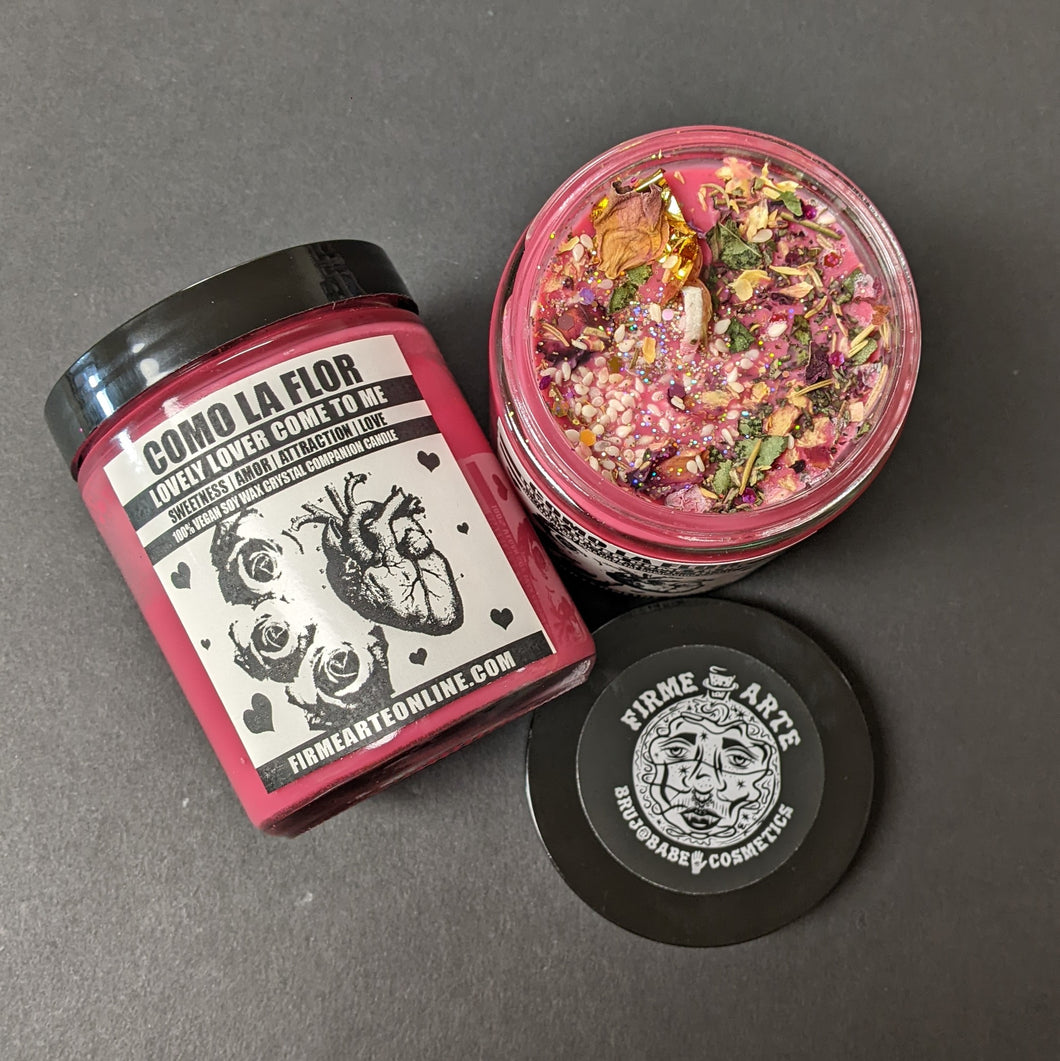 Red soy wax candle in glass jar with black lid. Features white label with black artwork of an anatomical heart and roses. available at Coyote Supply Co, a zero waste witch store in Midtown Reno, Nevada that is BIPOC owned