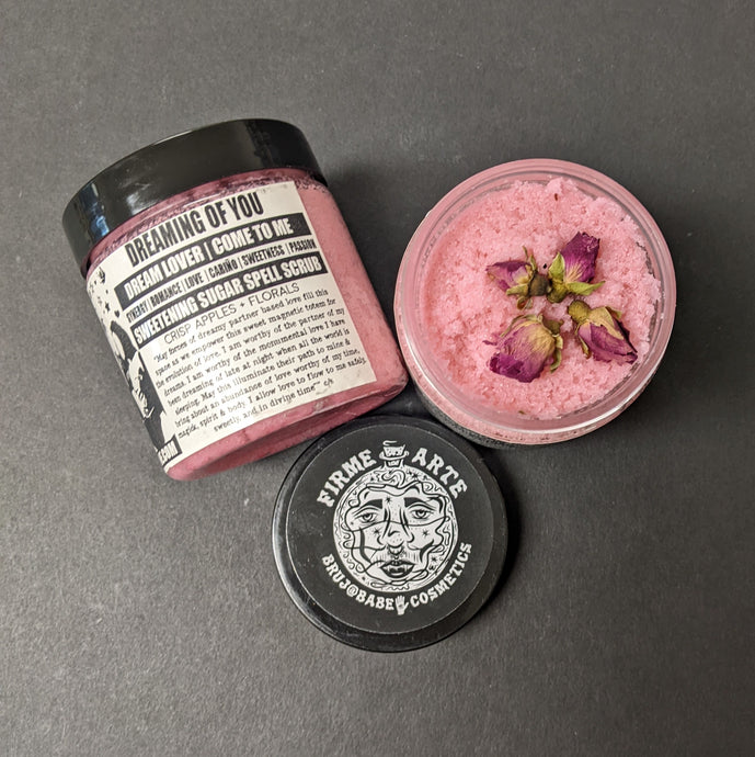 Pink sugar scrub in a plastic container with a black and white label that reads Dreaming of You. Sold at Coyote Supply Co a BIPOC and LGBTQIA+ owned zero waste witch store in Reno Nevada