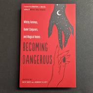 A red book cover that reads Witchy Femmes, Queer Conjurers, and Magic Rebels 'BECOMING DANGEROUS' with black illustrations of two hands reaching out to one another. 
Sold at Coyote Supply Co a BIPOC and LGBTQIA+ owned zero waste witch store in Reno Nevada