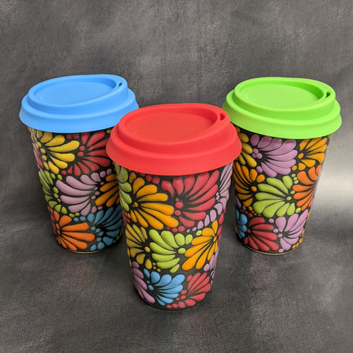 Three black travel mugs with a rainbow floral Talavera pattern against a grey background, each with a silicone lid.
Sold at Coyote Supply Co a BIPOC and LGBTQIA+ owned zero waste witch store in Reno Nevada