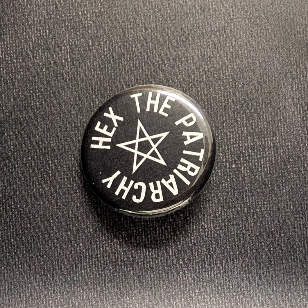 Black button with a white star in the center, around the star is white text that reads 