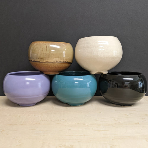 Five round glossy ceramic cauldrons in varying colors on a black background. The colors from left to right top to bottom are light brown, white, purple, blue, and black.

Sold at Coyote Supply Co a BIPOC and LGBTQIA+ owned zero waste witch store in Reno Nevada