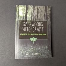 Load image into Gallery viewer, A book cover depicting an ominous forest that reads Backwoods Witchcraft Conjure &amp; Folk Magic From Appalachia by Jake Richards. Sold at Coyote Supply Co a BIPOC and LGBTQIA+ owned zero waste witch store in Reno Nevada