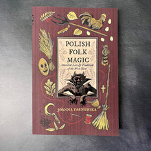Load image into Gallery viewer, A red paperback book on a dark background. The cover reads:
Polish Folk Maic 
Ancestral Lore &amp; Traditions of the West Slavs
Joanna Tarnawska

This item is sold at Coyote Supply Co a BIPOC and LGBTQIA+ owned zero waste witch store in Reno Nevada