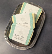 Three yellow soap bars with white bands in a silver plate on a black background. The white bands have black text that reads:
Organic Olive
Olive Oil Soap Bar
Palm-Oil Free * Organic Ingredients
No Chemical Preservatives * Vegan

This item is sold at Coyote Supply Co a BIPOC and LGBTQIA+ owned zero waste witch store in Reno Nevada