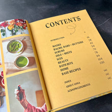 Load image into Gallery viewer, The Upcycled Beauty book open to its table of contents pictured on a dark background.
This item is sold at Coyote Supply Co a BIPOC and LGBTQIA+ owned zero waste witch store in Reno Nevada