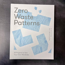 Load image into Gallery viewer, A white paperback cover book on a dark background. 
The book cover reads:
Zero Waste Patterns
Birgitta Helmersson
20 projects to sew your own wardrobe

This item is sold at Coyote Supply Co a BIPOC and LGBTQIA+ owned zero waste witch store in Reno Nevada