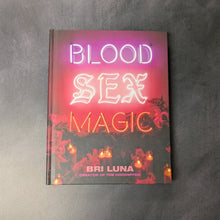 Load image into Gallery viewer, A red hardcover book on a dark background. The cover reads:
Blood
Sex
Magic
Folkelore
Bri Luna
Creator of the Hoodwitch

This item is sold at Coyote Supply Co a BIPOC and LGBTQIA+ owned zero waste witch store in Reno Nevada