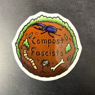 A sticker of a cartoon round patch of earth with a worm, beetle, and weevil. There is black text in the center.
The text reads:
Compost
Fascists

Sold at Coyote Supply Co a BIPOC and LGBTQIA+ owned zero waste witch store in Reno Nevada
