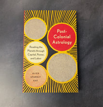 Load image into Gallery viewer, A yellow and black paperback book on a dark background. The cover reads:
Post-
Colonial
Astrology
Reading the
Planets through
Capital, Power, 
and Labor
Alice
Sparkly
Kat

This item is sold at Coyote Supply Co a BIPOC and LGBTQIA+ owned zero waste witch store in Reno Nevada