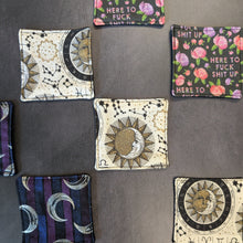 Load image into Gallery viewer, An assortment of reusable cotton squares with colorful varying patterns pictured on a dark background