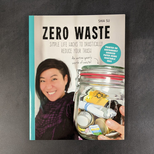 A paperback book cover with a photo of an Asian woman smiling holding a mason jar full of trash at the viewer. The cover reads:
Shia Su
ZERO WASTE
SIMPLE LIFE HACKS TO DRASTICALLY REDUCE YOUR TRASH

Sold at Coyote Supply Co a BIPOC and LGBTQIA+ owned zero waste witch store in Reno Nevada