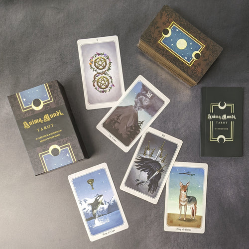 An assortment of tarot cards from the Anima Mundi Tarot deck alongside a stack of the other cards, the deck box, and the guide book on a black background.
Sold at Coyote Supply Co a BIPOC and LGBTQIA+ owned zero waste witch store in Reno Nevada