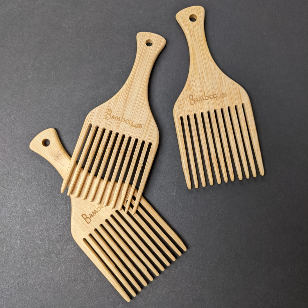 Three bamboo hair picks on a black background.  Sold at Coyote Supply Co a BIPOC and LGBTQIA+ owned zero waste witch store in Reno Nevada 