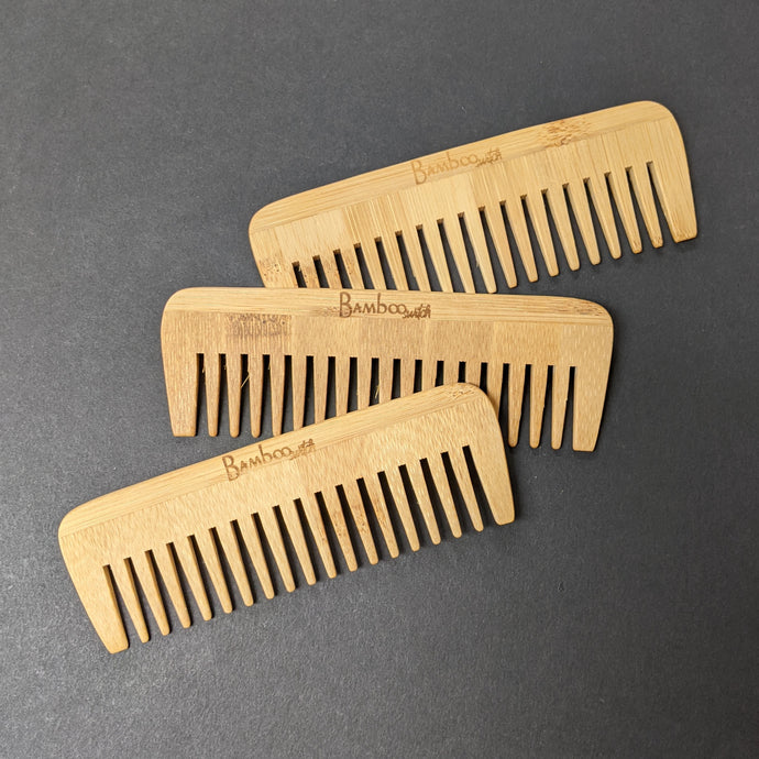Three bamboo combs on a black background.  Sold at Coyote Supply Co a BIPOC and LGBTQIA+ owned zero waste witch store in Reno Nevada 