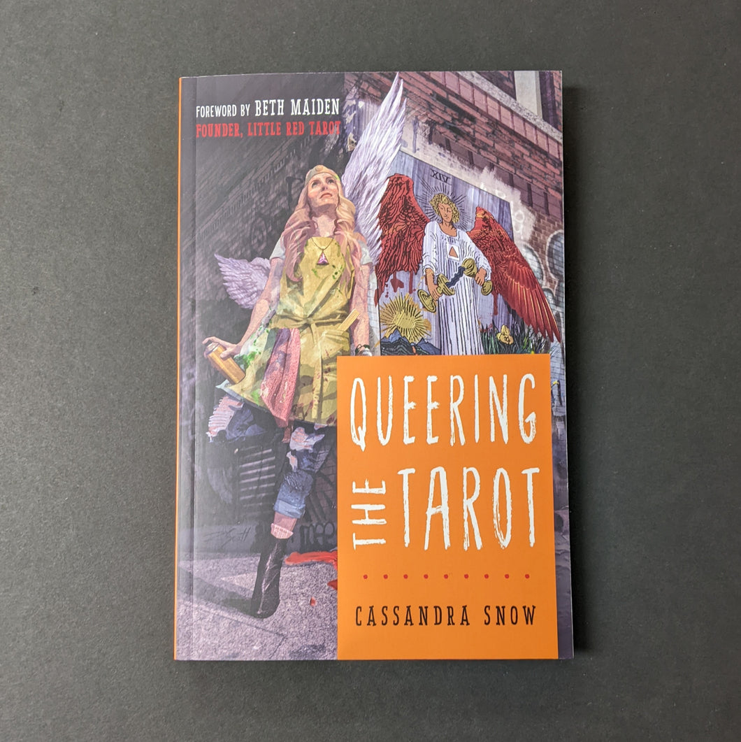 An illustrated book cover depicting a woman holding a spray paint cand next to a mural of the tarot card Temperance by Cassandra Snow. Reads Queering the Tarot in thin white letters. Available at Coyote Supply Co, a zero waste witch store in Midtown Reno, Nevada that is BIPOC owned