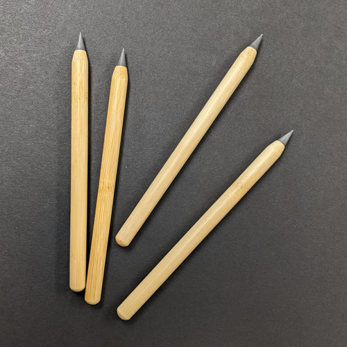 Four bamboo forever pencils on a black background.  Sold at Coyote Supply Co a BIPOC and LGBTQIA+ owned zero waste witch store in Reno Nevada 