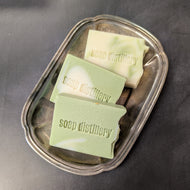 Three white and green soap bars in a silver plate on a black background. The soap bars are stamped with the brand name Soap Distillery.

This item is sold at Coyote Supply Co a BIPOC and LGBTQIA+ owned zero waste witch store in Reno Nevada