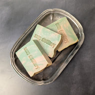 Three yellow and green soap bars in a silver plate on a black background. The soap bars are stamped with the brand name Soap Distillery.

This item is sold at Coyote Supply Co a BIPOC and LGBTQIA+ owned zero waste witch store in Reno Nevada