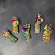 Five herbal smoke bundles on a dark background.

This item is sold at Coyote Supply Co a BIPOC and LGBTQIA+ owned zero waste witch store in Reno Nevada