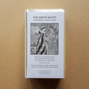 The white paper guidebook of the Smith-Waite Centennial Edition tarot deck.  Detail shows the deck is shrink wrapped.