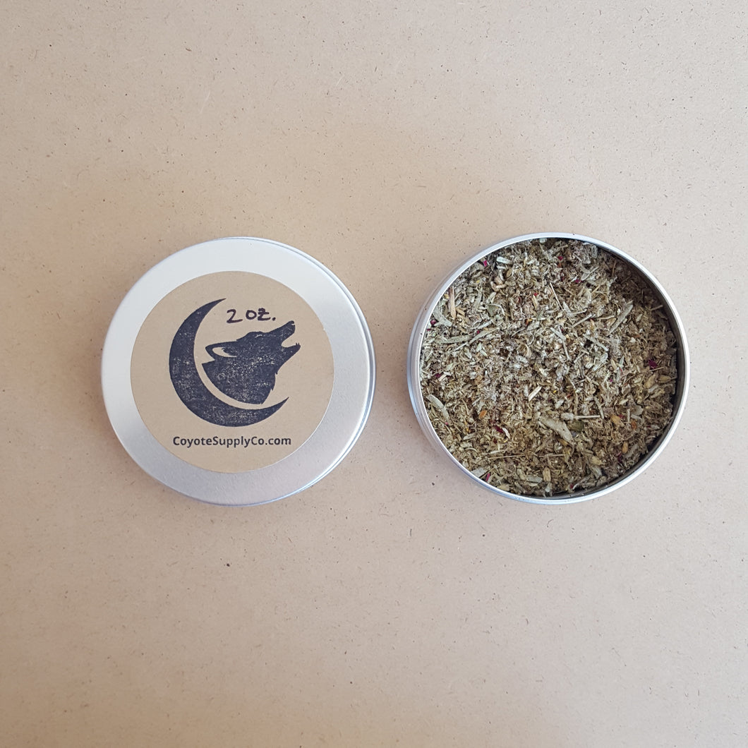 Left: round aluminium tin lid with round kraft label that has been hand stamped with the Coyote Supply Co. logo of a crescent moon cradling a howling coyote head.  Right: round aluminium tin full of ground herbs and spices available at Coyote Supply Co, a zero waste witch store in Midtown Reno, Nevada that is BIPOC owned
