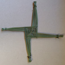 Load image into Gallery viewer, A squared off cross, called a Brigid&#39;s Cross, made of green rushes on particle board background  available at Coyote Supply Co, a zero waste witch store in Midtown Reno, Nevada that is BIPOC owned