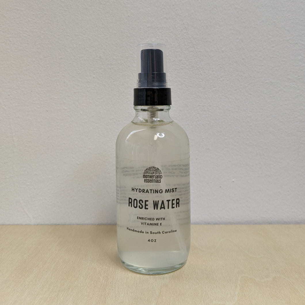 Clear glass bottle with black spray lid containing rose water by Motherland Essentials  available at Coyote Supply Co, a zero waste witch store in Midtown Reno, Nevada that is BIPOC owned