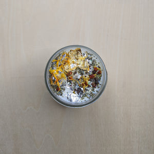 White soy wax candle topped with marigold petals, herbs, and gold leaf by Firme Arte available at Coyote Supply Co, a zero waste witch store in Midtown Reno, Nevada that is BIPOC owned