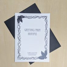 Load image into Gallery viewer, Black ink thorny border and holly illustration on white paper reads &quot;Greetings from Krampus&quot; in black.