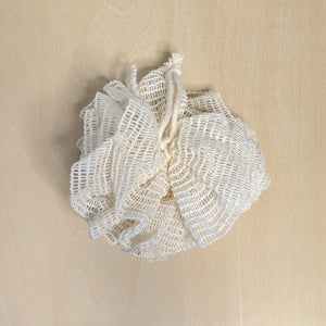 Undyed ramie mesh bath pouf with hanging loop  available at Coyote Supply Co, a zero waste witch store in Midtown Reno, Nevada that is BIPOC owned